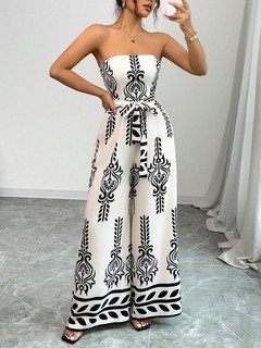 Styled front view of the white and black ornamental strapless jumpsuit, showing its silhouette and design details.