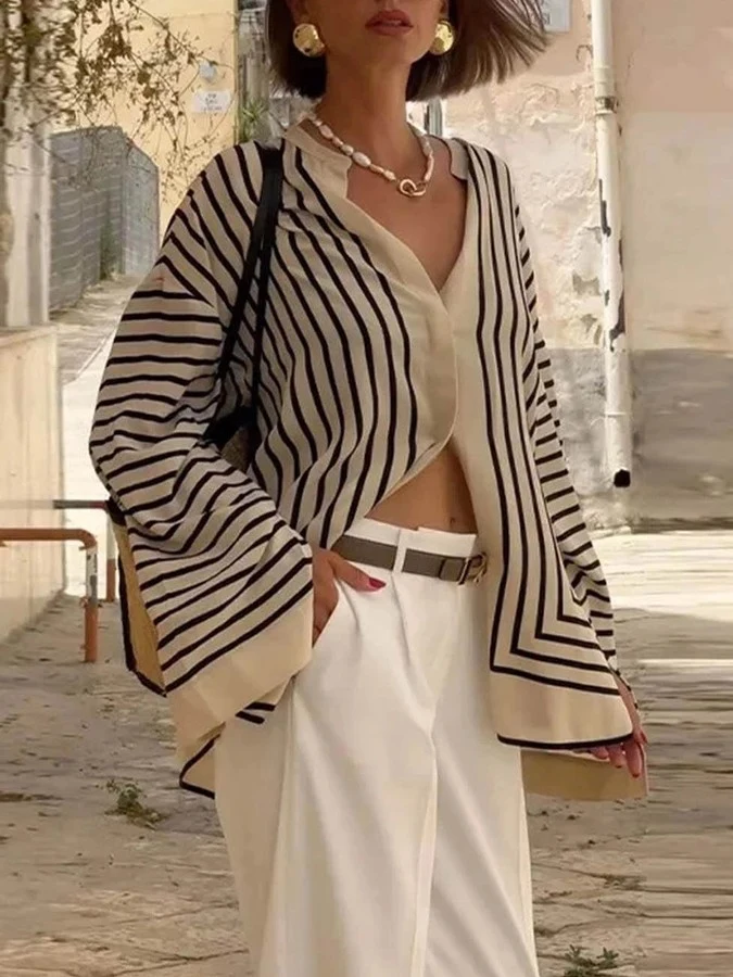 Angled front view of the cream and black striped border hem shirt, showing its silhouette and design details.