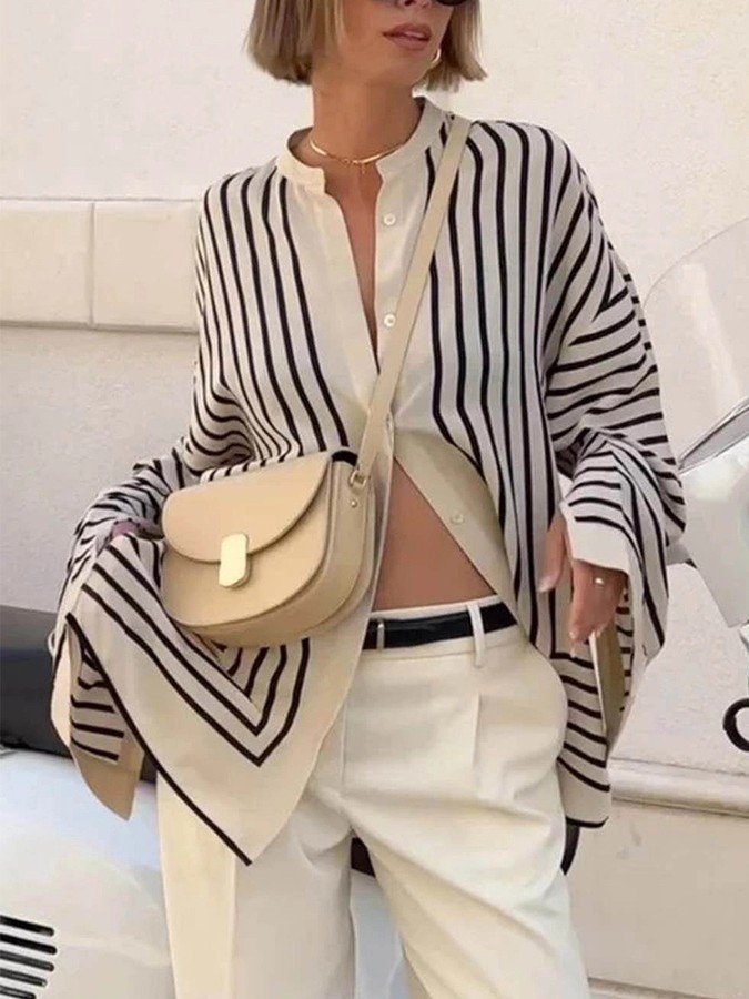 Front view of the cream and black striped border hem shirt, showing its silhouette and design details.