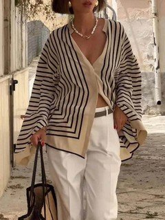 Full-length front view of the cream and black striped border hem shirt, showing its silhouette and design details.