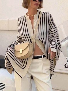 Lifestyle front view of the cream and black striped border hem shirt, showing its silhouette and design details.