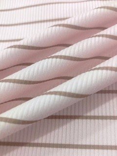 Ribbed fabric detail of the pink pink striped lace-trim v-neck long-sleeve top, showing fine stripes, lace-trim v-neck and long sleeves.