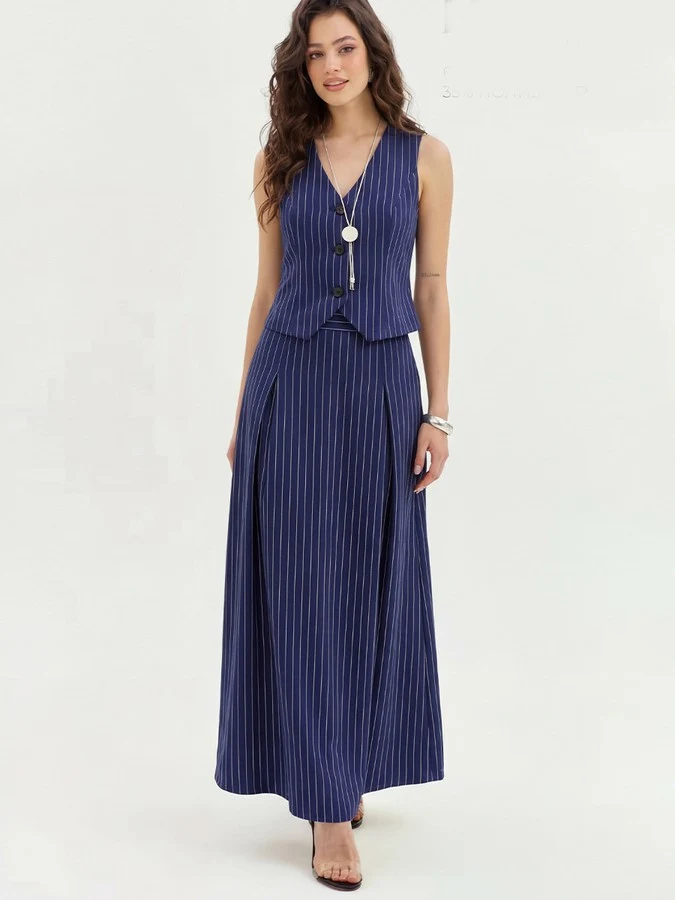 Angled front view of the navy pinstripe vest and maxi skirt set, showing its silhouette and design details.