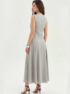 Angled back view of the light gray pinstripe vest and maxi skirt set, showing its silhouette and design details.