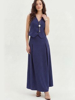 Styled front view of the navy pinstripe vest and maxi skirt set, showing its silhouette and design details.