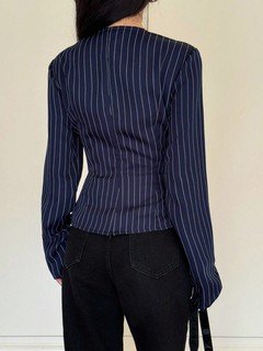 Back view of the navy pinstripe ruched-waist blouse, showing its silhouette and design details.