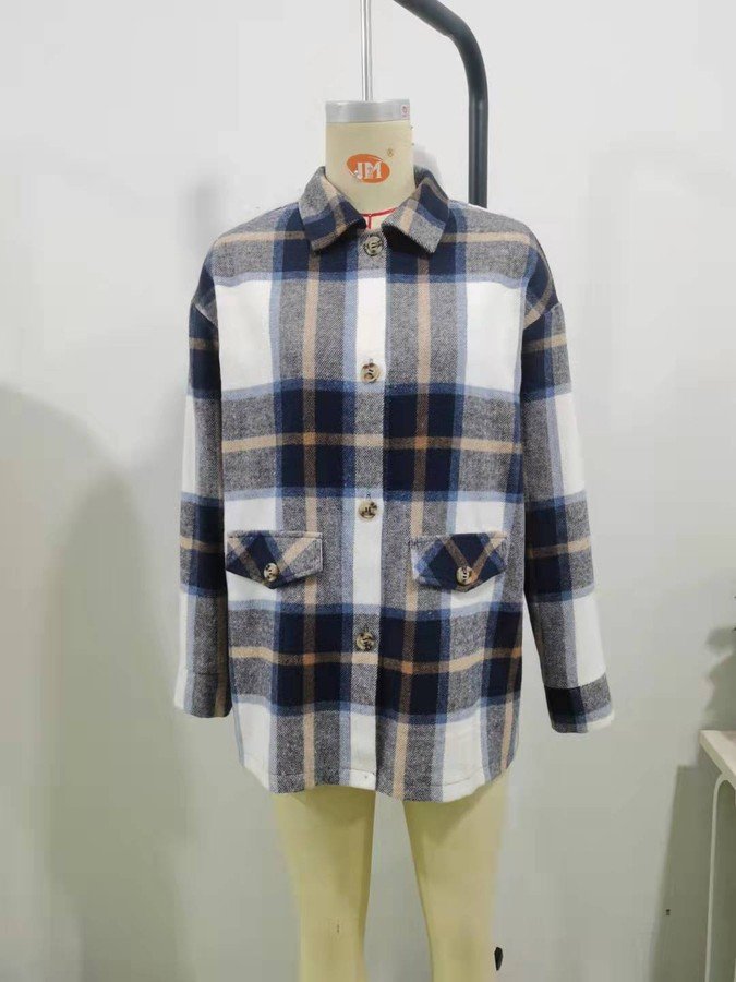 Mannequin view of the blue plaid flap-pocket shirt jacket, showing the garment shape and construction.
