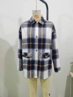 Mannequin view of the blue plaid flap-pocket shirt jacket, showing the garment shape and construction.