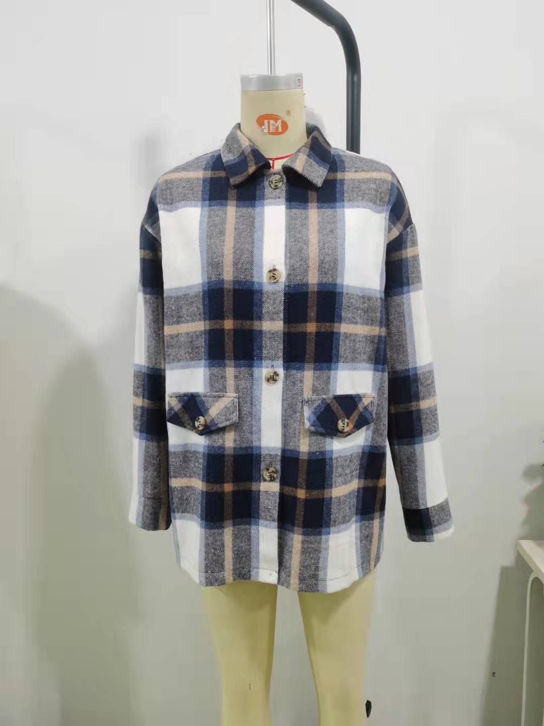 Blue Plaid Flap-Pocket Shirt Jacket – Mannequin View Mannequin view of the blue plaid flap-pocket shirt jacket, showing the garment shape and construction.