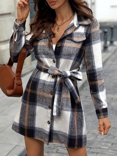 Lifestyle front view of the navy plaid belted shirt dress, showing its silhouette and design details.