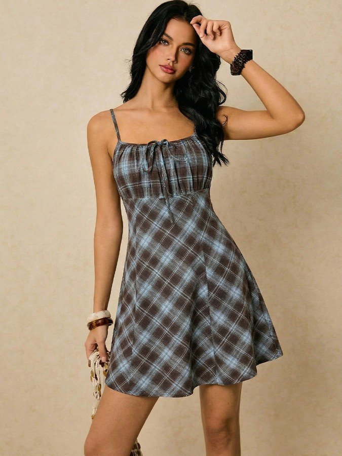 Angled front view of the gray and blue plaid ruched-bust mini dress, showing its silhouette and design details.