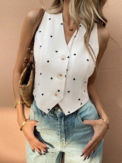 Lifestyle front view of the white polka-dot cropped tailored vest, showing its silhouette and design details.
