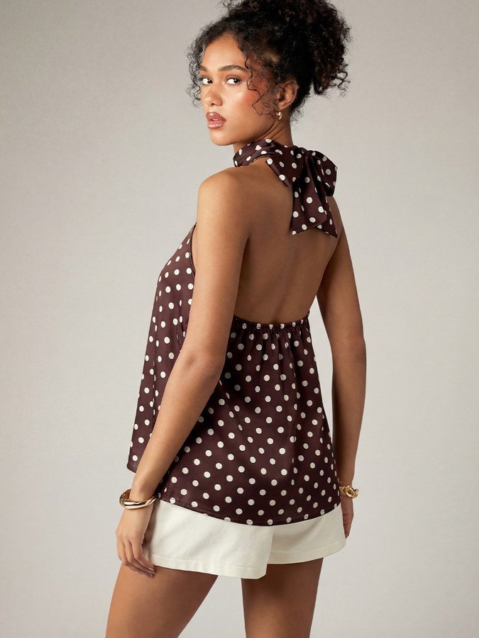 Back view of the brown polka-dot cross-halter top, showing its silhouette and design details.