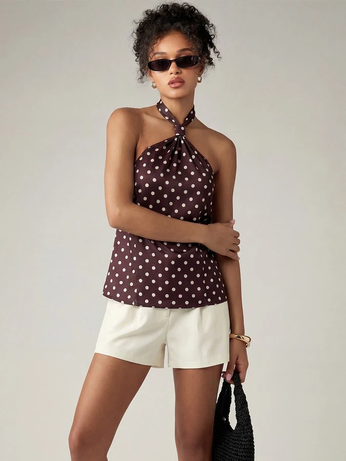 Front view of the brown polka-dot cross-halter top, showing its silhouette and design details.