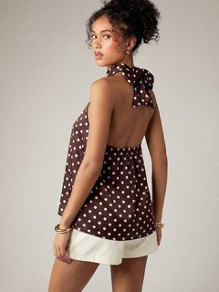 Back view of the brown polka-dot cross-halter top, showing its silhouette and design details.