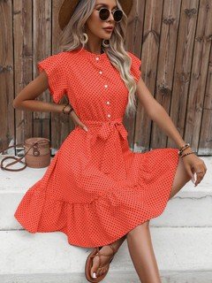Front view of the coral polka-dot ruffle hem shirt dress, showing its silhouette and design details.
