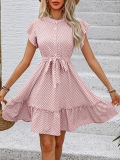 Front view of the pink polka-dot ruffle hem shirt dress, showing its silhouette and design details.