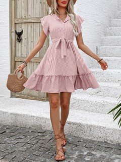 Full-length front view of the pink polka-dot ruffle hem shirt dress, showing its silhouette and design details.