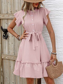 Styled front view of the pink polka-dot ruffle hem shirt dress, showing its silhouette and design details.