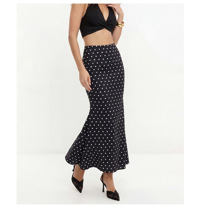 Front view of the black polka-dot fishtail maxi skirt, showing its silhouette and design details.