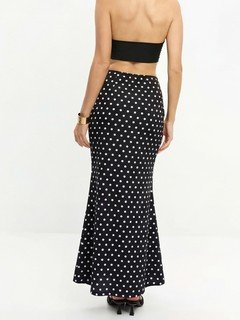 Back view of the black polka-dot fishtail maxi skirt, showing its silhouette and design details.