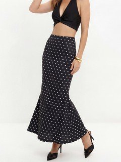 Full-length front view of the black polka-dot fishtail maxi skirt, showing its silhouette and design details.