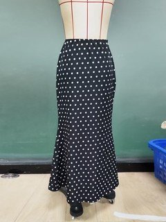 Mannequin view of the black polka-dot fishtail maxi skirt, showing the garment shape and construction.