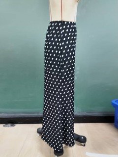 Mannequin view of the black polka-dot fishtail maxi skirt, showing the garment shape and construction.