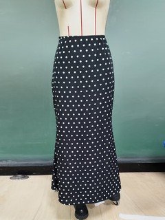Mannequin view of the black polka-dot fishtail maxi skirt, showing the garment shape and construction.