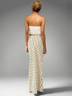 Back view of the cream polka-dot fishtail maxi skirt, showing its silhouette and design details.