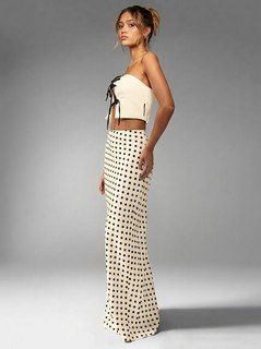 Front view of the cream polka-dot fishtail maxi skirt, showing its silhouette and design details.