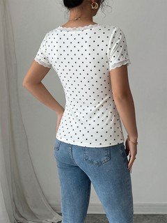 Back view of the white polka-dot lace-trim v-neck short-sleeve top, showing the silhouette and fit.