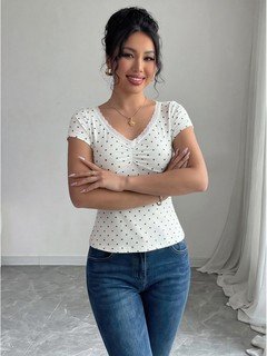 Styled front view of the white polka-dot lace-trim v-neck short-sleeve top, showing the silhouette and fit.