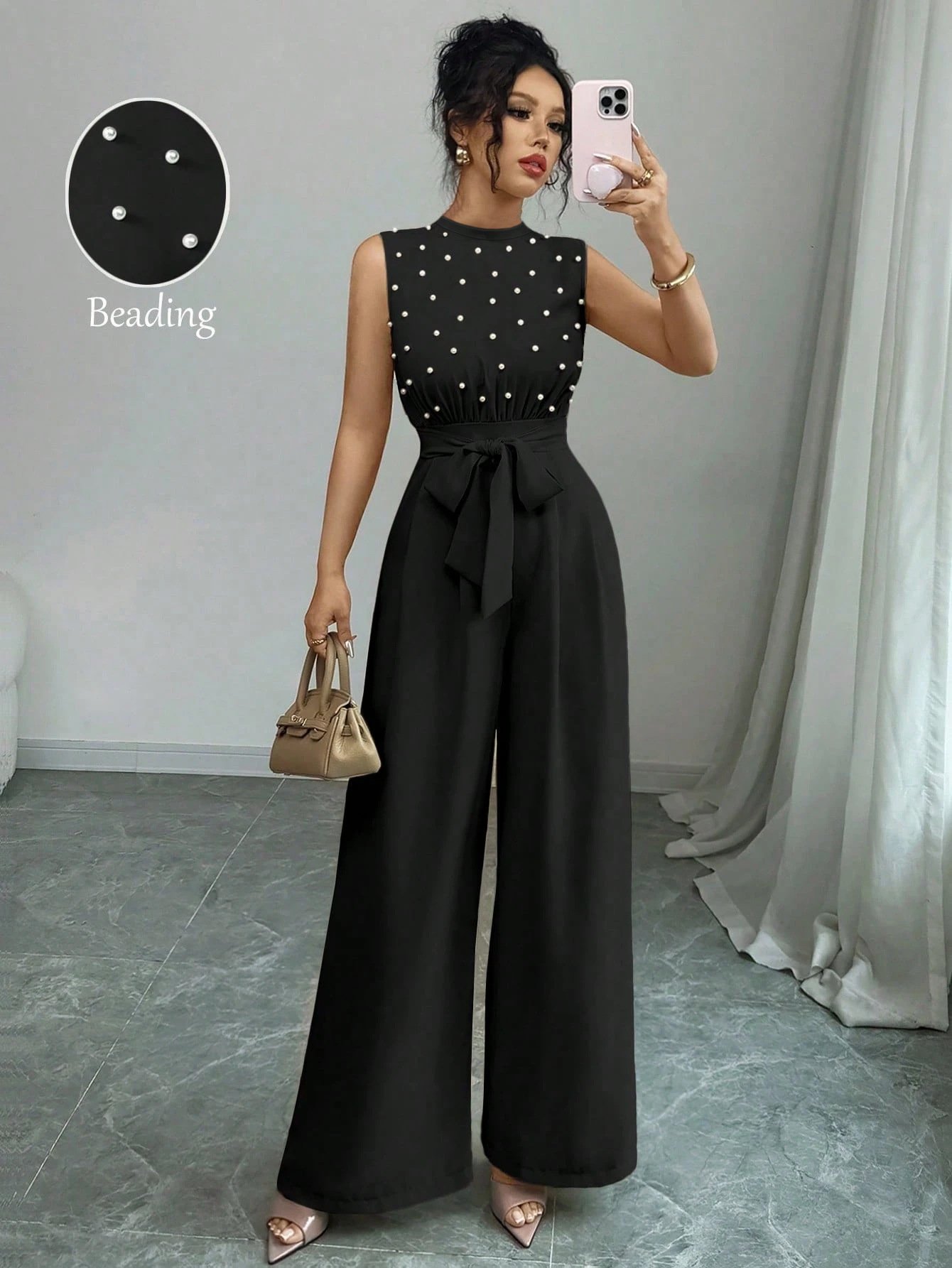 Black Polka-Dot Sleeveless Tie-Waist Wide-Leg Jumpsuit – Front View Front view of the black polka-dot sleeveless tie-waist wide-leg jumpsuit, showing the silhouette and fit.