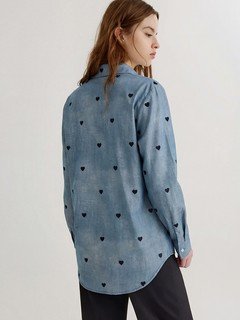 Back view of the blue polka-dot twist-front shirt, showing its silhouette and design details.