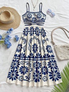 Styled flat lay of the blue porcelain floral smocked-bodice spaghetti-strap maxi dress, showing the garment shape and available styling.