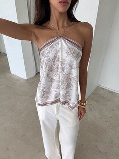 Lifestyle front view of the beige printed halter scarf top, showing its silhouette and design details.