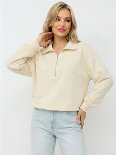 Angled front view of the cream quarter-zip collared sweatshirt, showing its silhouette and design details.