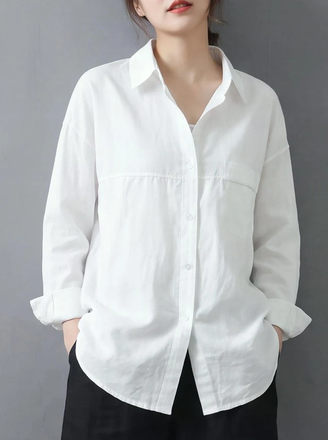 Alternate front view of the white relaxed button-up long-sleeve shirt, showing the silhouette and fit.