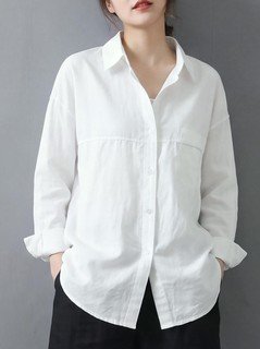Alternate front view of the white relaxed button-up long-sleeve shirt, showing the silhouette and fit.