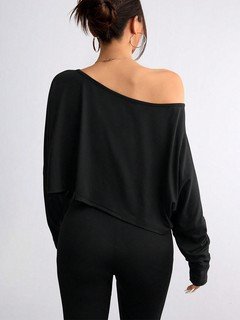 Back view of the black off-shoulder high-low crop top, showing its silhouette and design details.