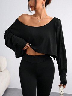 Front view of the black off-shoulder high-low crop top, showing its silhouette and design details.