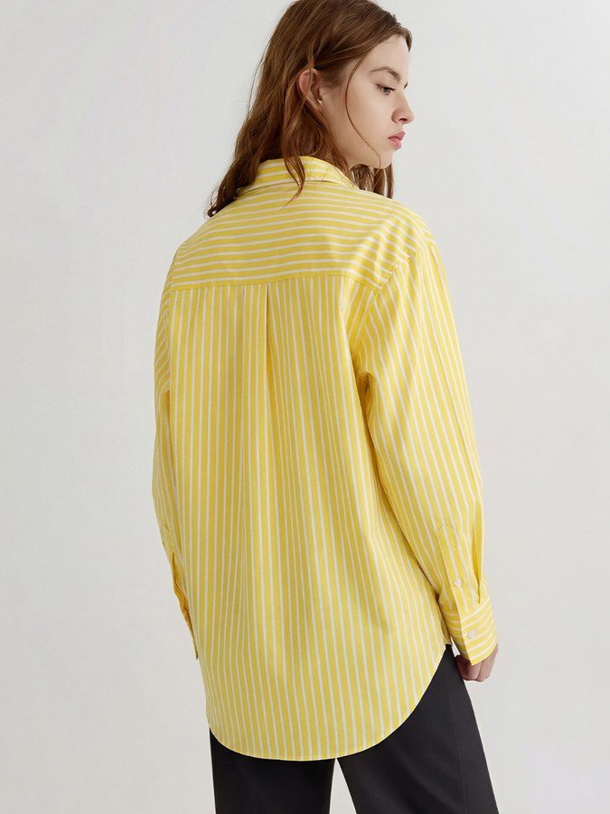 Back view of the yellow striped button-front shirt, showing its silhouette and design details.