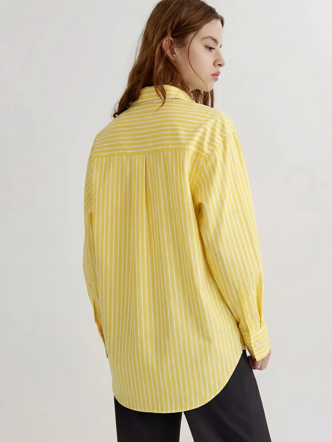 Back view of the yellow striped button-front shirt, showing its silhouette and design details.