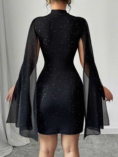 Back view of the black rhinestone cape sleeve mini dress, showing its silhouette and design details.