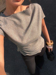 Neckline detail of the taupe ruched-waist short-sleeve fitted top, showing soft neckline, gathered waist and fitted silhouette.