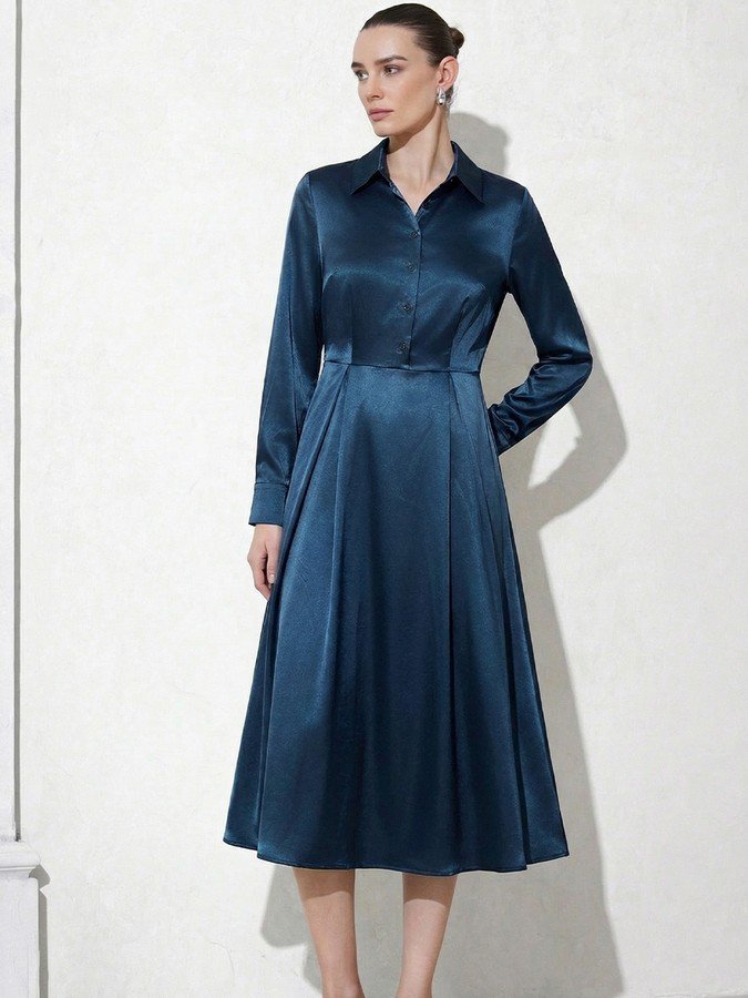 Angled front view of the teal satin a-line midi shirt dress, showing its silhouette and design details.