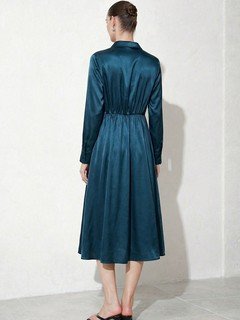 Back view of the teal satin a-line midi shirt dress, showing its silhouette and design details.
