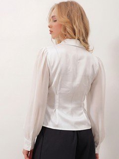 Back view of the ivory satin button-detail wrap blouse, showing its silhouette and design details.