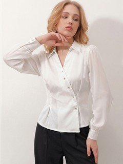 Three-quarter front view of the ivory satin button-detail wrap blouse, showing its silhouette and design details.
